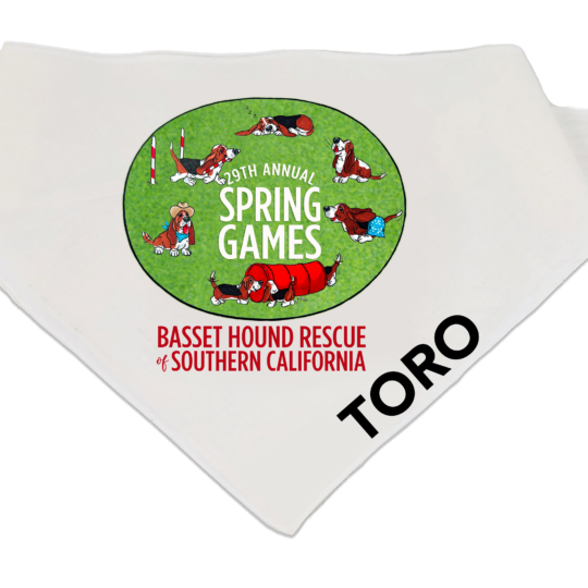 White dog bandana featuring a green oval “29th Annual Spring Games” design with illustrated basset hounds playing, and “Basset Hound Rescue of Southern California” text below.